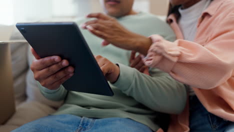 Hands-of-couple-on-sofa,-tablet