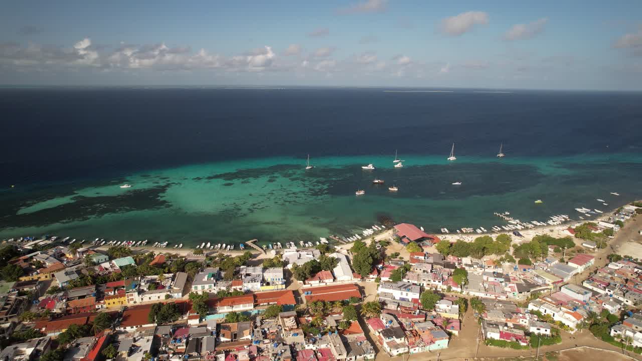 Gran roque island village and turquoise waters on a sunny day, aerial view
