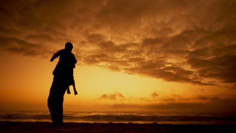 sunset, father and lifting a kid in air at beach