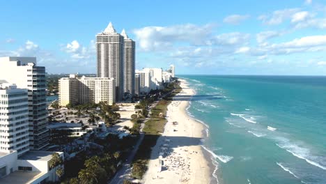 people on sandy beachfront in island city resort in mid-beach area in miami beach, florida, usa