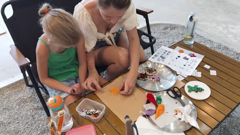 mother and daughter decorating cookies