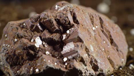 detailed close-up of a unique rock formation showcasing intricate textures and shimmering mineral deposits in a natural setting
