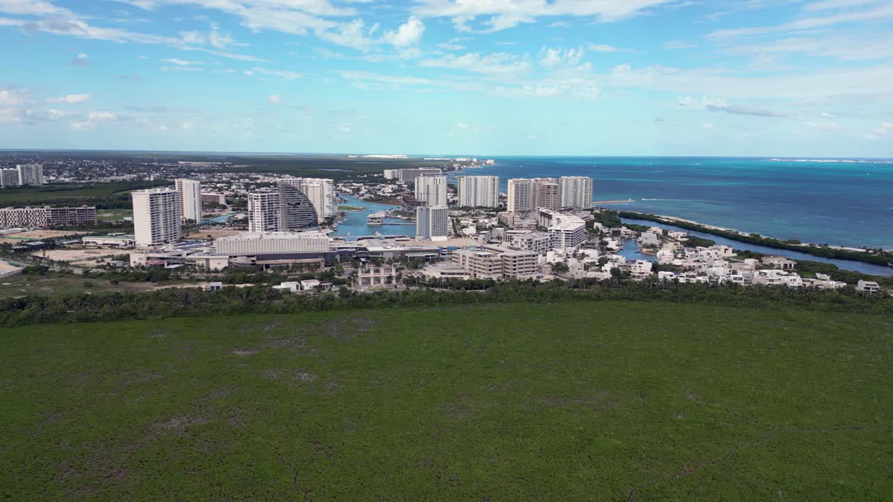 Mangrove swamp on edge of Cancun cityscape on Caribbean coast, aerial