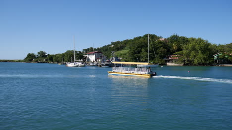 water taxi leaving harbor in castries, st. lucia.