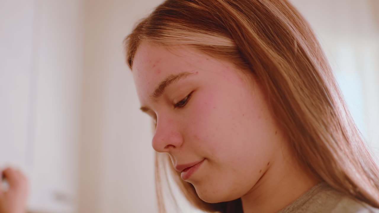 Accountant reaching into cabinet to collect coffee container in warm kitchen, preparing morning drink with natural sunlight filling background, beginning daily routine