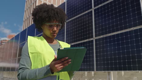 woman inspecting solar panels