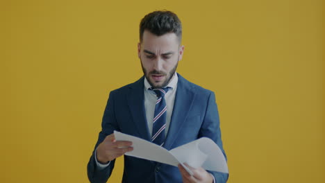 businessman reacts to documents and celebrates