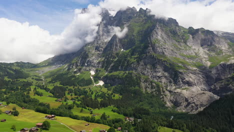 Cinematic-drone-shot-flying-towards-mountainside-in-Grindelwald,-in-Switzerland’s-Bernese-Alps