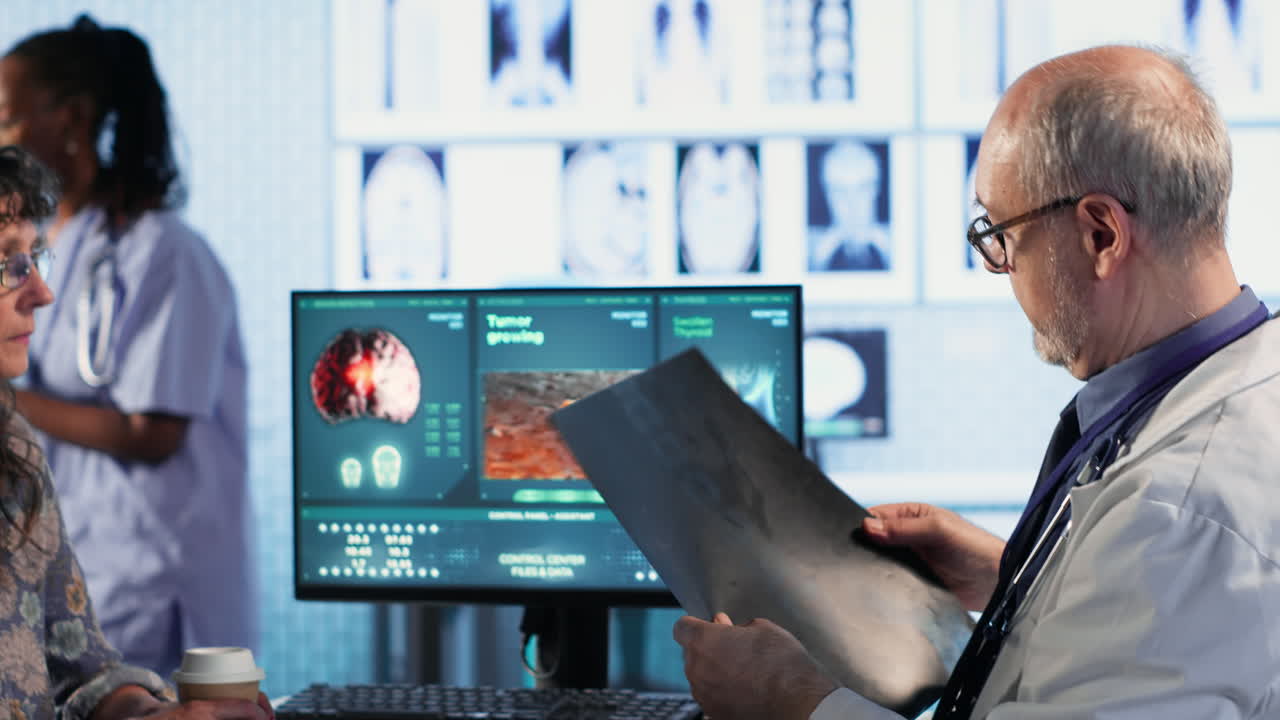 Vertical Video Oncology consultation takes place as a senior medic explains radiology scan