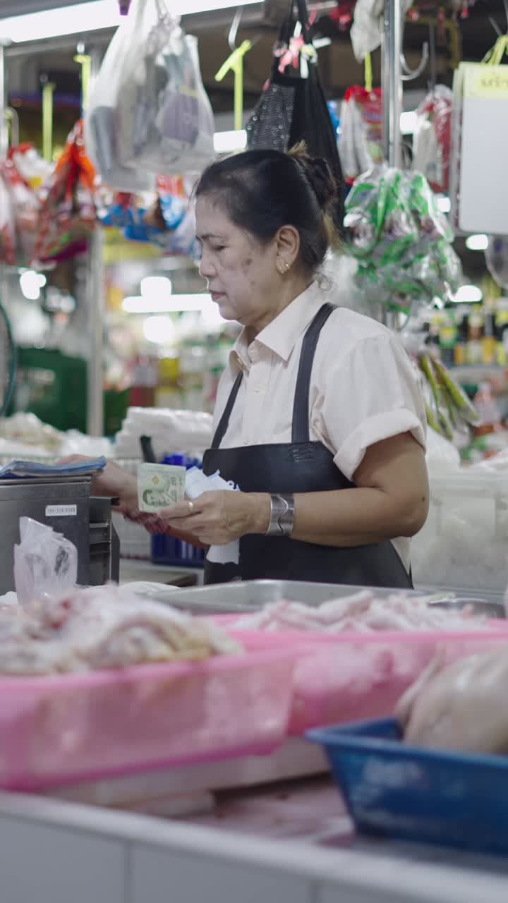 A woman selling chicken at a market