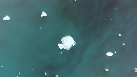 vertical drone shot over an iceberg in iceland jokursarlon lagoon