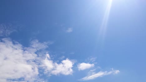 timelapse of cloud layers with bright sun flare