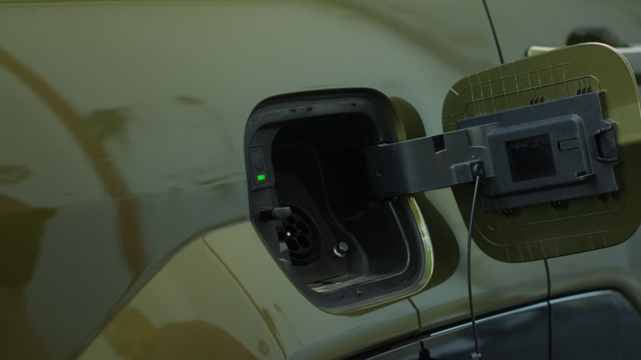 Close Up Of Driver Recharging Green Technology Ev Automobile Battery