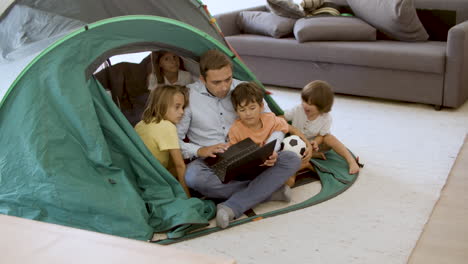 dad and children playing camping at home