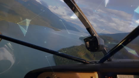 globe of plexus network spinning against front view of dashboard of private aircraft