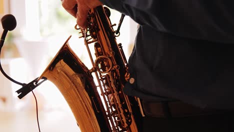 saxophonist plays the saxophone in a party hall