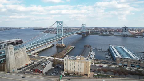 drone shot flying over interstate 95 in philadelphia towards the ben franklin bridge