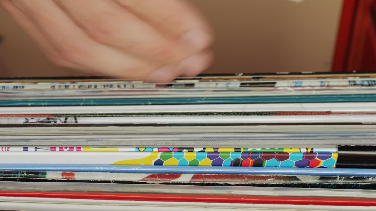 Man hands browsing vintage vinyl records at shop close-up. Searching music. Musical shopping. Retro Vinyl record player. High quality 4k footage