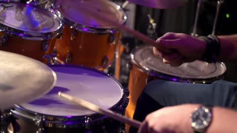 drummer enthusiastically rhythmically hits the drum kit