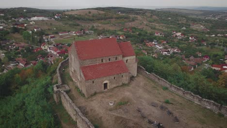 Helix-drone-shot-right-to-left-of-a-fortressed-church-in-Transylvania,-placed-on-top-of-a-hill