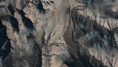 aerial view of a rugged desert landscape with winding roads