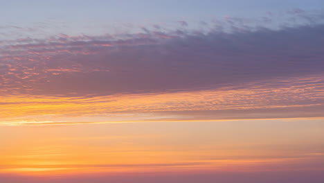 vibrant pastel sky at sunset or sunrise with layered clouds