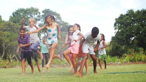 kids playing with garden sprinkler