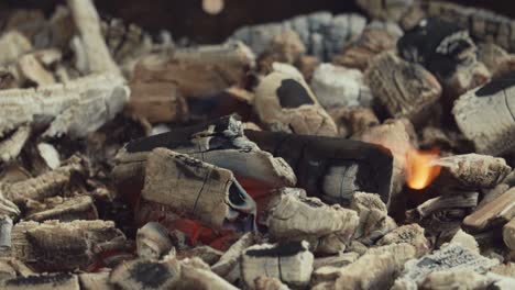 burning charcoal with white ashes in fire place