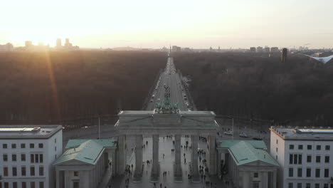 AERIAL:-Over-17th-of-June-Street-and-Tiergarten-with-Berlin-Victory-Column-revealing-Brandenburg-Gate-in-beautiful-Sunset-light