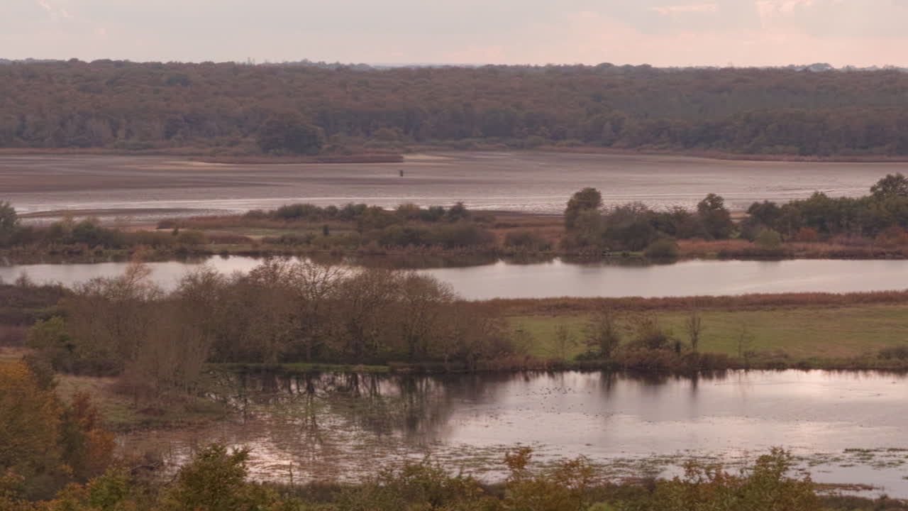 Autumnal view of La Mer Rouge pond in La Brenne, France known for traditional fish farming