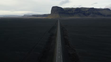 picturesque road in black sand beach coastline in iceland, aerial landscape