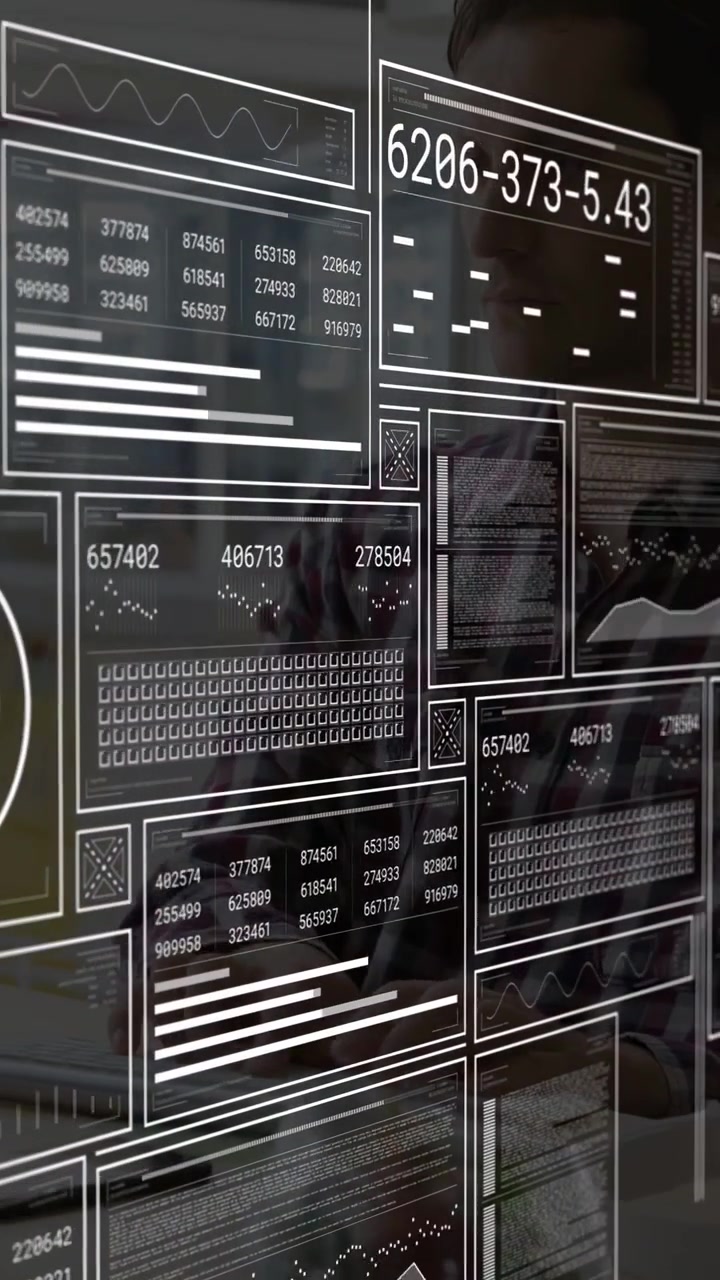 Vertical video: Analyst typing at glass keys causing HUD panels scrolling revealing data for review