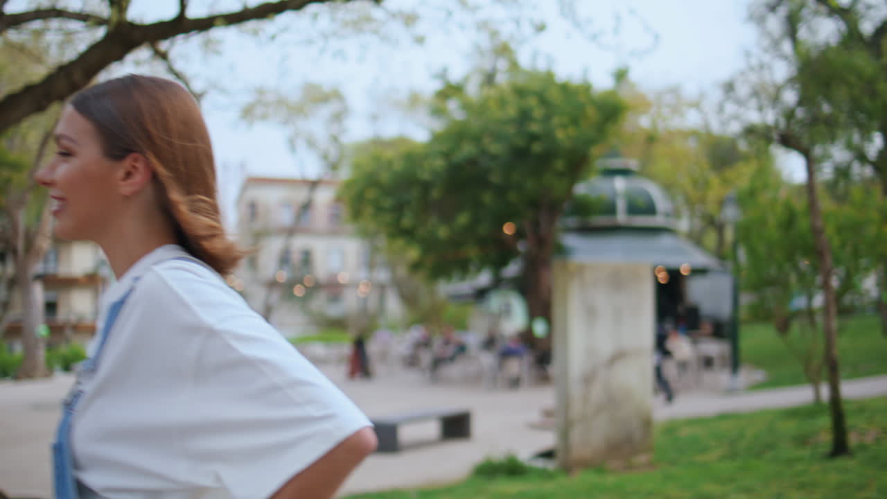 Trendy girl calling mobile phone enjoying urban walk closeup. Happy woman finish