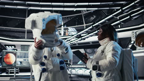 cosmonaut doing fist bump with colleague, leaving starship to descend on planet