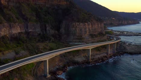 sea cliff bridge along australian pacific ocean coast on dusk in new south wales, australia