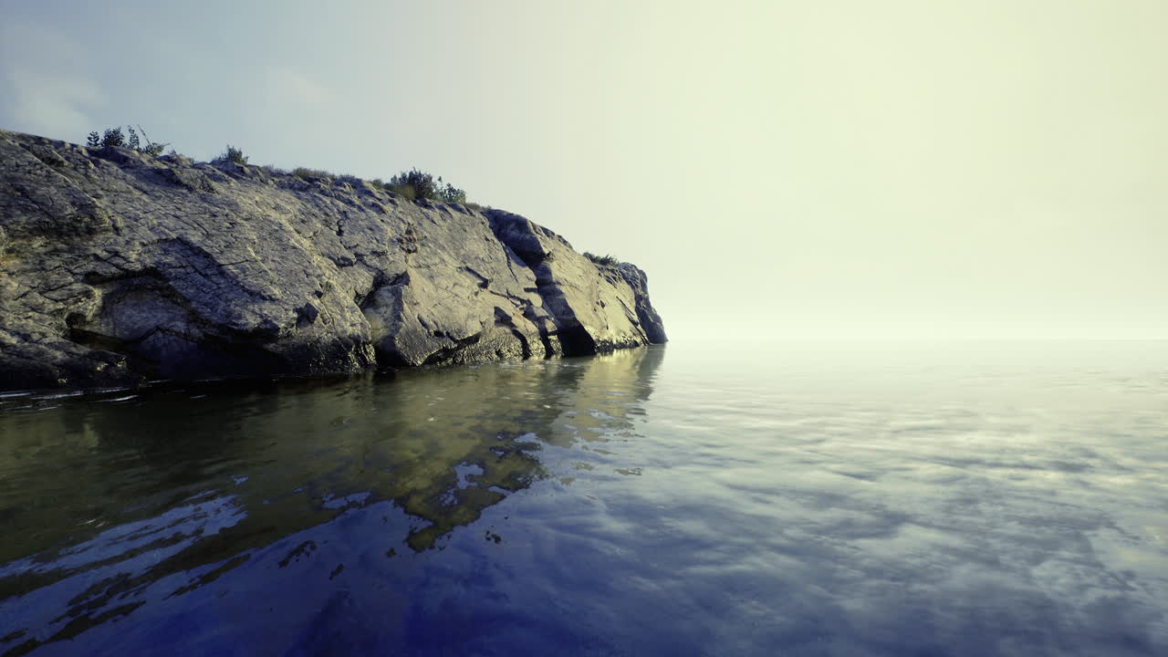 Peaceful shoreline at dawn with reflections on calm water