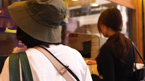 two people purchasing desserts at a bakery