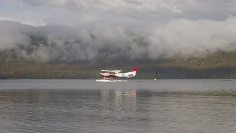 seaplane moving on surface of calm lake te anau on south island in new zealand