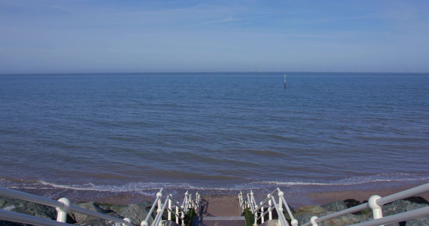 Extra wide shot looking down some Steps at High tide, on to traeth Hen Golwyn, Old Colwyn Beach at Colwyn Promenade, Old Colwyn