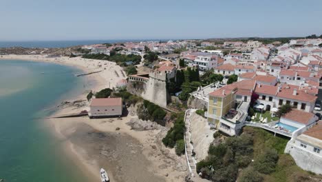 Pullback-from-São-Clemente-Fortress-on-Beautiful-coastal-village-of-Vila-Nova-de-Milfontes,-Portugal