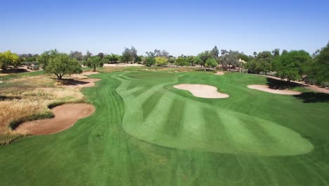 Aerial-fly-down-the-fairway-to-the-pin,-Scottsdale-Arizona