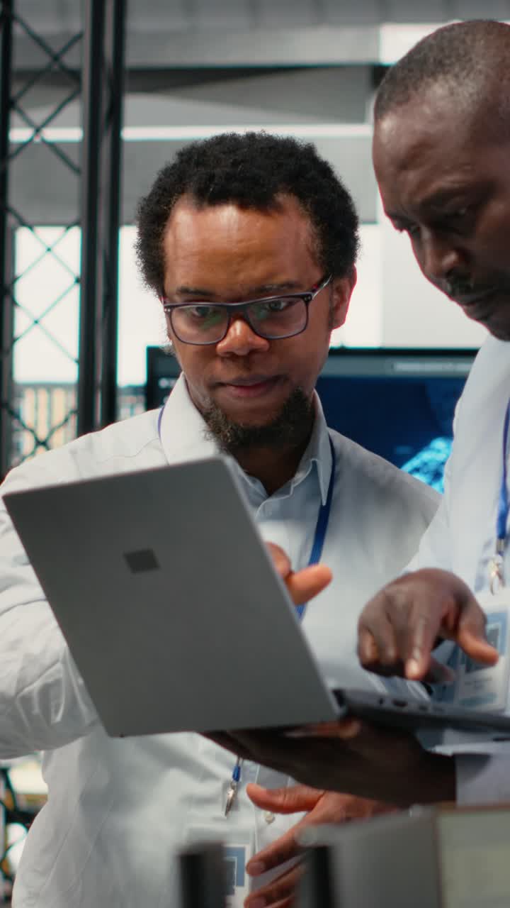 Vertical video Engineers in office doing software development to launch new features