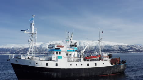 Aerial-Drone-view-Polar-Fjord-Cruise-Ship-Sailing-in-the-Arctic-Sea-in-Tromso,-Norway