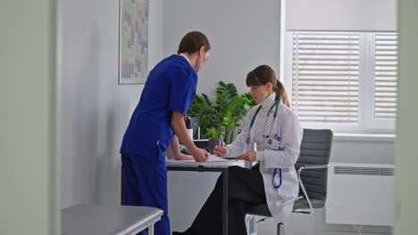 doctor and nurse discussing patient records