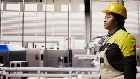 vertical video engineer in smart factory overseeing robotic assembly lines