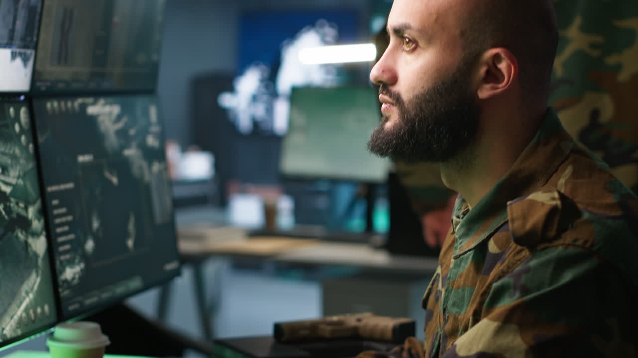 Close up of intelligence corps expert controlling drones attacking targets