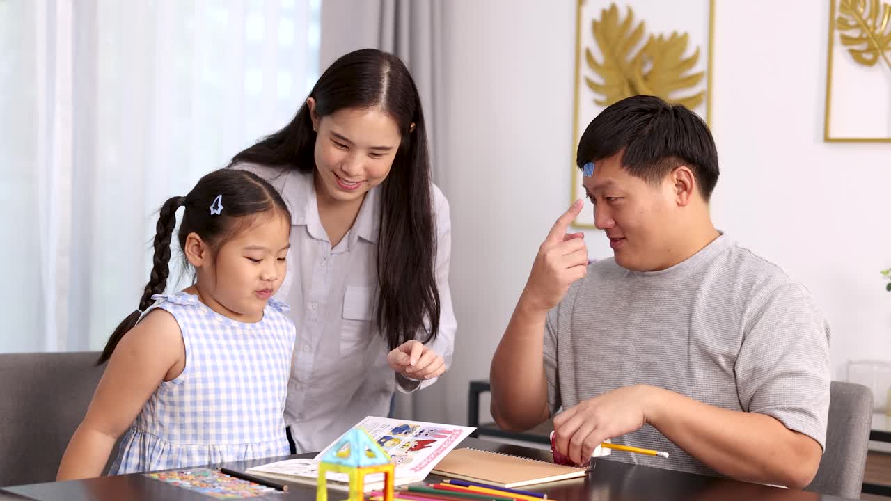 Parents and daughter laugh and interact while doing educational activities in bright, cozy living room
