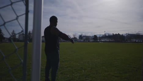Male Arms Crossed and Stretching With Headphones On - Strong Athletic Muscular Black Man Fitness Outdoor Training Preparation In 4K