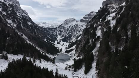 Close-Up-Drone-View-Of-Frozen-Mountain-Lake-Tahlalpsee-Filzbach-Glarus-Nord-Schweiz