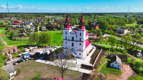 beautiful lithuanian countryside with a church, aerial shot in vibrant spring weather